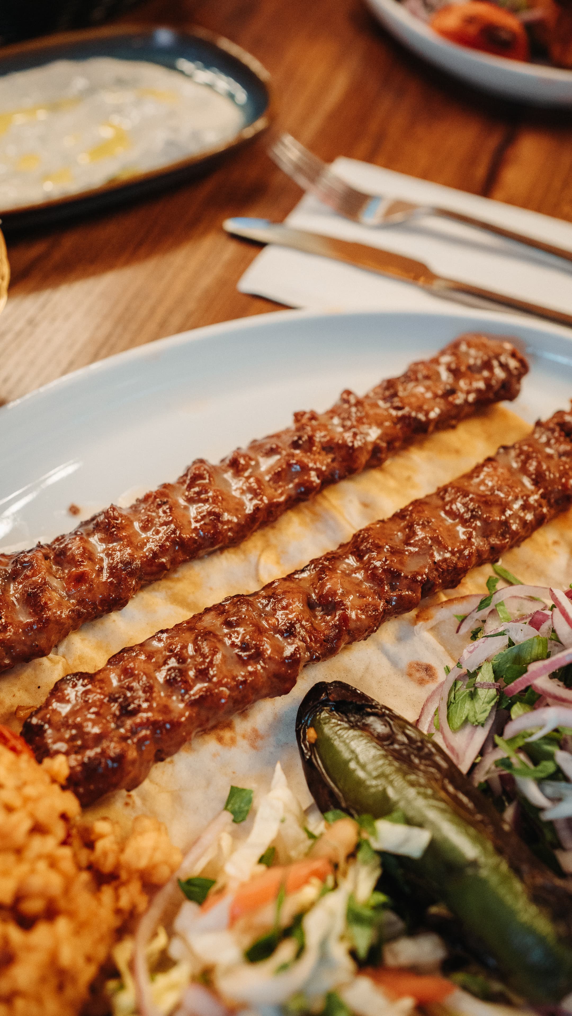 Two long lines of adana on lavash