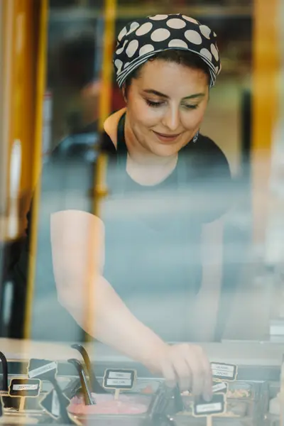Staff member at the counter behind glass