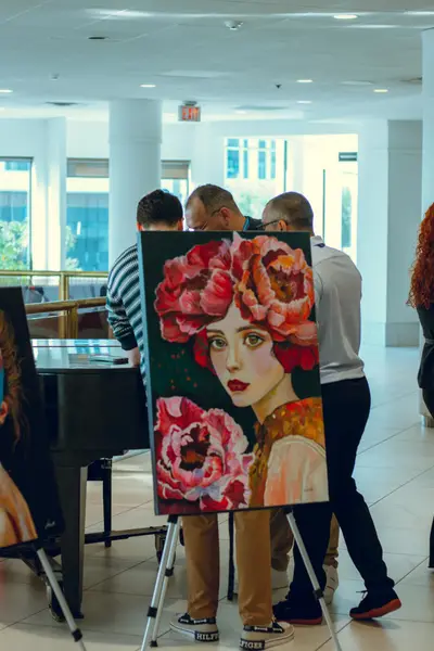 A portrait painting displayed on an easel in the culture area