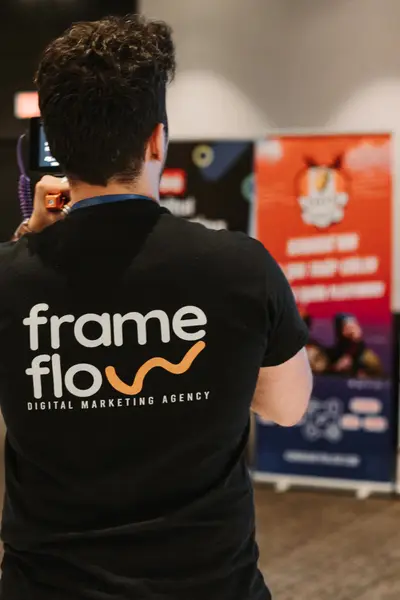 A FrameFlow crew member filming on the exhibitor floor