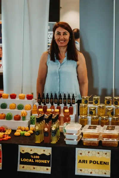 A vendor's table of local honey jars