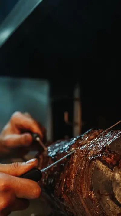 Cağ kebabı, mid-rotation above oak embers