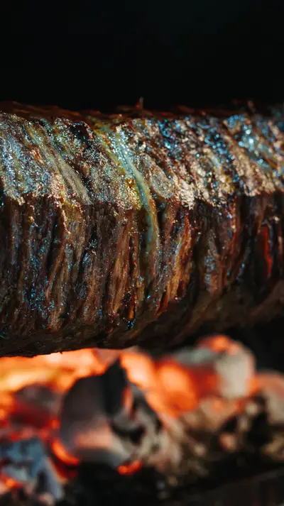 The chef carves the cağ with a long blade