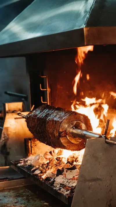 The first dark crust on the rotating roast