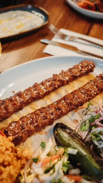 Two long lines of adana on lavash