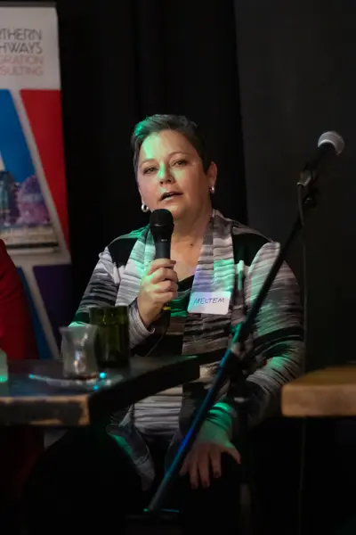 A speaker addressing the room with a microphone