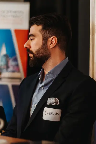 A guest in profile beside the event banner