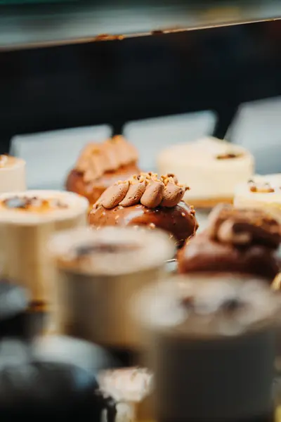 A close view along the pastry case, cakes receding