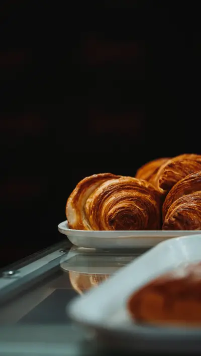 Croissants stacked on a white tray