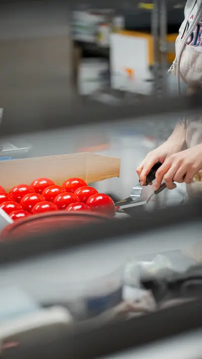 Lifting red-glazed domes from the production rack