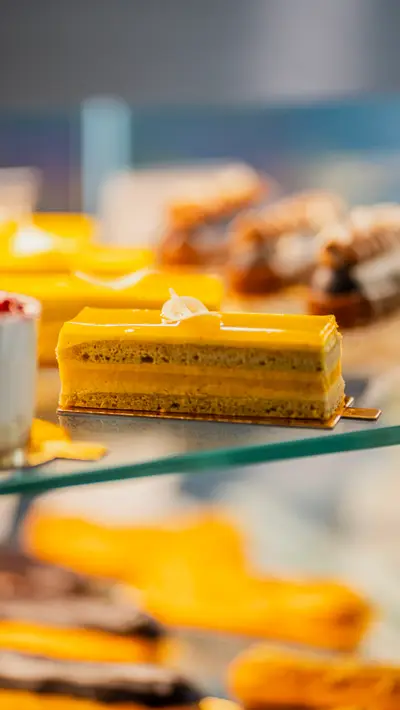 A yellow layered slice on the glass shelf