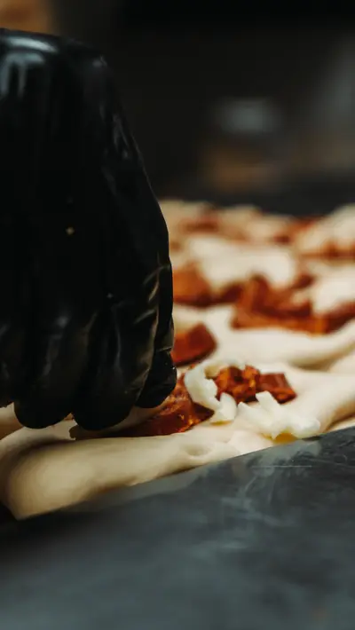Laying pieces of fruit along a sheet of rolled dough