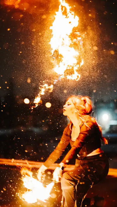 A plume of fire rising above the performer