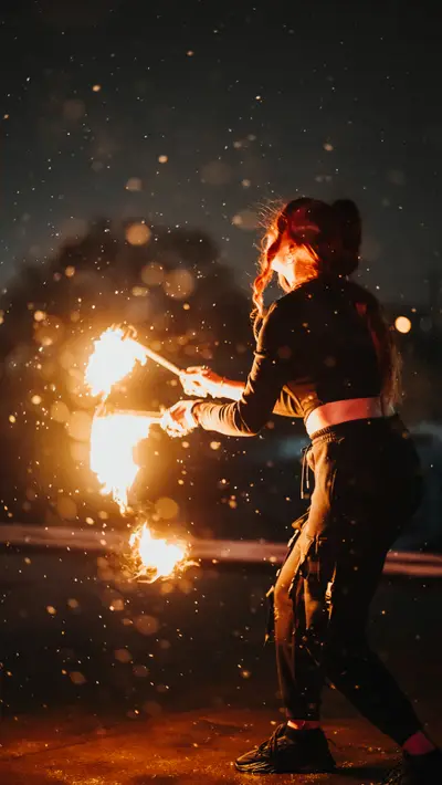 A fire fan sweeping a wide arc of sparks