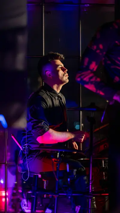 A DJ working the decks in violet light