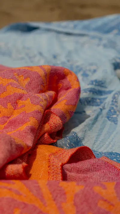Coral and blue patterned towels folded together
