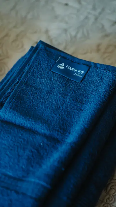 A folded blue robe with the woven label showing