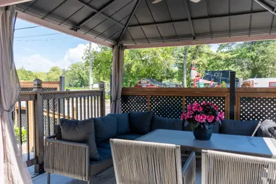 Gazebo seating and table with flowers on the deck