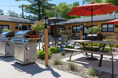 The courtyard with barbecues, picnic tables and red parasols