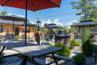A picnic table with gazebos and cabins behind