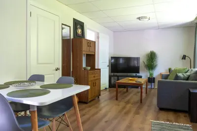 A white dining table with the living area behind