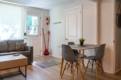 A dining set beside the entry door and sofa