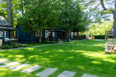 A stone path crossing the lawn between cabins