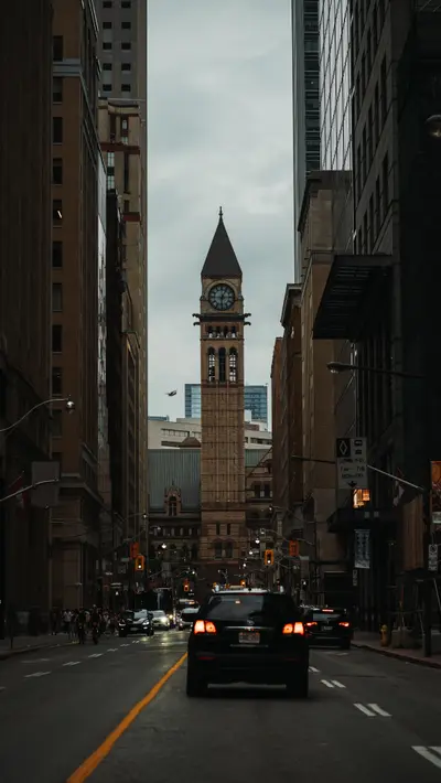 Traffic on the avenue with the clock tower ahead
