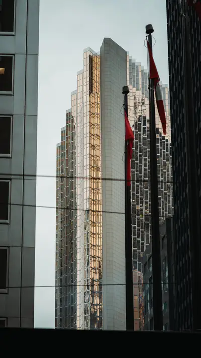 Glass towers with a flag flying between them