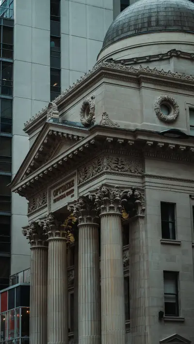 A columned stone facade with a dome above