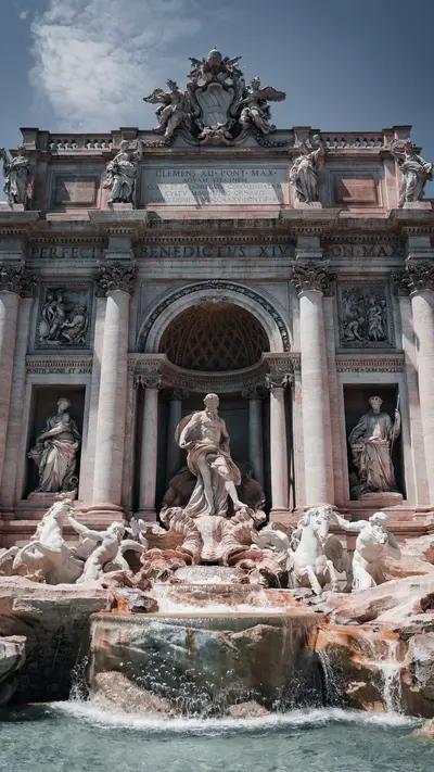 The Trevi Fountain with water falling over the rocks