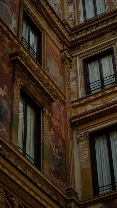 A gilded and painted facade with tall shuttered windows