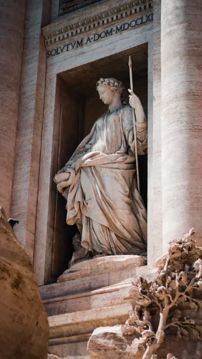 A robed statue standing in a columned niche