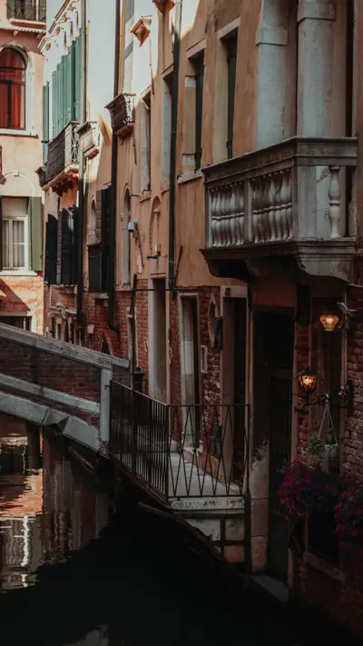 Balconies leaning over a quiet canal